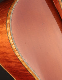 Close-up of a guitar top highlighting a bit of light play wear.