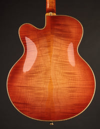 Photo of a sunburst archtop guitar's back.