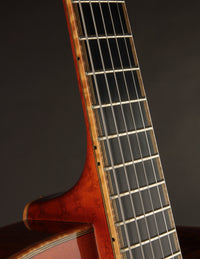 Close-up of a guitar neck with a dark background