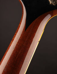 Close-up of a guitar neck with a dark background