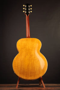 Electric guitar on a stand against a dark background