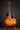 1961 Sunburst Gibson ES-335TD on a stand against a dark background.
