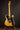 Electric guitar on a stand against a dark background