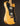Wooden electric guitar with a black pickguard on a dark background