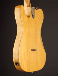 Wooden electric guitar on a dark background