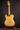 Electric guitar on a stand against a dark background