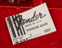 Fender Telecaster Deluxe owner's manual on a red background