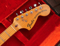 Fender Telecaster Deluxe guitar headstock on a red background
