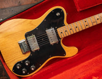 Electric guitar with a Natural finish in a red lined case