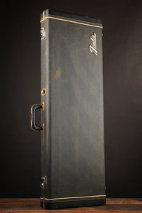 Vintage-style black Fender case on a dark background