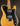 Electric guitar with a blonde finish and black pickguard on a dark background