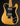 Electric guitar with a black pickguard and wooden body on a dark background