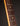 Close-up of a guitar neck with frets and strings on a dark background