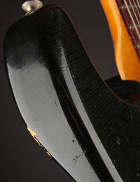 Close up of finish checking and strap button on a Black 1968 Fender Stratocaster