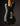 Back view of a black 1968 Fender Stratocaster electric guitar with visible wear on a dark background