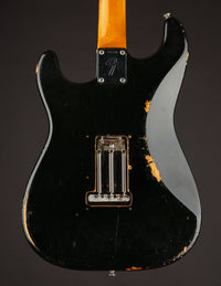 Back view of a black 1968 Fender Stratocaster