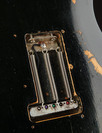 Close up of springs and tremolo block on a black 1968 Fender Stratocaster