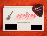 Fender guitar pick on a business card on an orange background