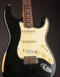 Black 1968 Fender Stratocaster against a dark background