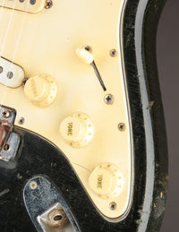 Close-up of control knobs and body on a Black 1968 Fender Stratocaster