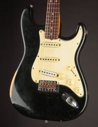 Black 1968 Fender Stratocaster, close up of body