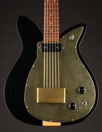 Black and gold electric guitar on a dark background