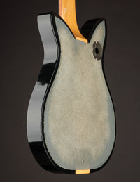Back view of a black electric guitar on a dark background