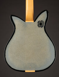 Back view of a guitar on a dark background