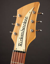 Close-up of a Rickenbacker guitar headstock on a dark background