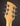 Close-up of a guitar headstock with tuning pegs on a dark background