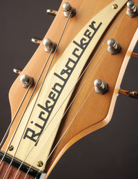 Close-up of a Rickenbacker guitar headstock with visible branding.