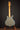 Guitar on a stand against a dark background