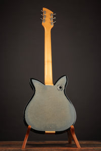 Guitar on a stand against a dark background