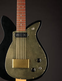 Black and gold electric guitar on a dark background
