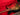Electric guitar with gold pickguard in a case with red interior 