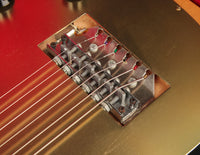 Close-up of a guitar bridge with strings