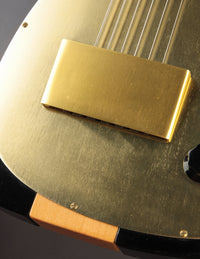Close up of bridge on a vintage electric guitar with gold pickguard