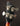 Close-up of a bass guitar headstock with tuning pegs on a dark background