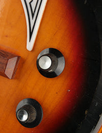 Close-up of a bass' control knobo on a sunburst finish.
