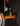 Vintage electric bass guitar with a sunburst finish on a dark background, close up of back