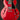 Red electric guitar with a black pickguard on a dark background