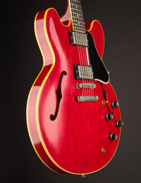Red electric guitar on a black background