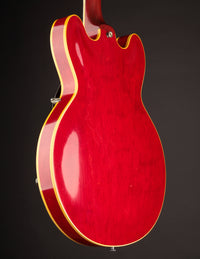 Red electric guitar on a black background