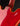 Close-up of a red guitar with a black background