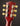 Close-up of a red guitar headstock with tuning pegs on a dark background