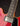 Close-up of a red electric guitar's neck and body on a black background
