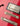 Close-up of a red electric guitar with a focus on the bridge and strings.