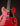 Red electric guitar with a black pickguard on a dark background