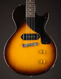 Electric guitar with a sunburst finish on a dark background