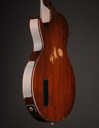 Back view of an electric guitar on a dark background